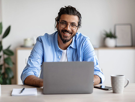 smiling man with laptop