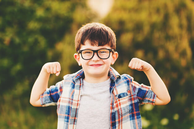 young boy wearing kid's glasses